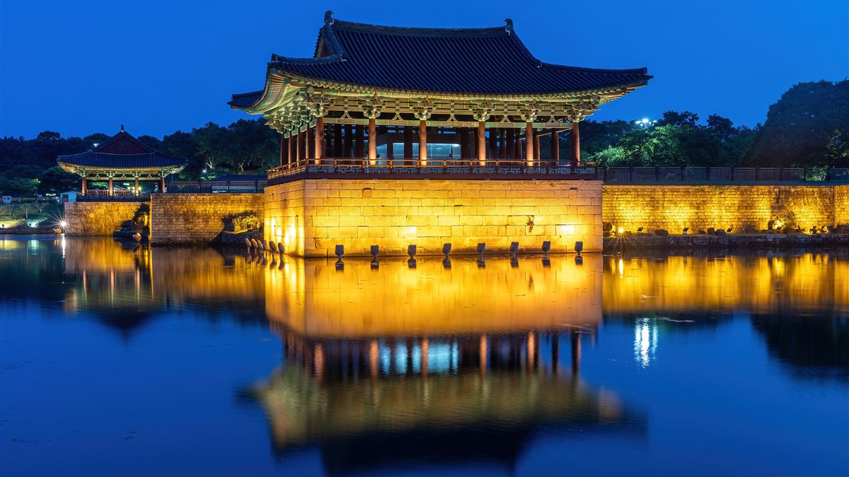 Donggung Palace pavilion lit up at dusk and reflected in Wolji Pond